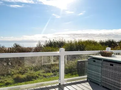 a balcony with a view of the ocean at Gill Bay - Uk45513 in Mainsriddle