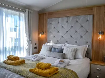 a bedroom with a large bed with towels on it at Gill Bay - Uk45513 in Mainsriddle