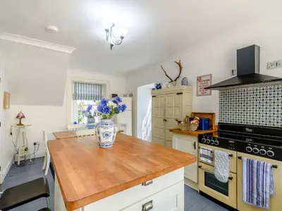 a kitchen with a counter with a vase on it at Priory Walk in Newton Stewart