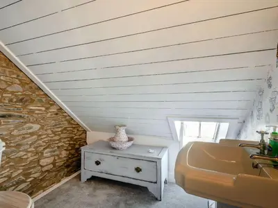 a bathroom with a sink and a stone wall at Priory Walk in Newton Stewart