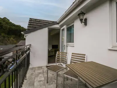 a patio with a table and chairs on a balcony at Apartment 6 in Keswick