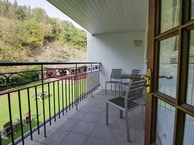 a balcony with chairs and a table and a view at Apartment 1 in Keswick