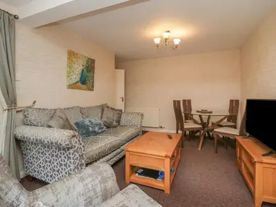 a living room with a couch and a table at Apartment 1 in Keswick