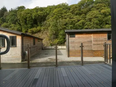 an open door to a cabin with a wooden deck at The Bothy in Keswick