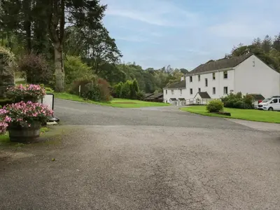 a driveway leading to a white house at Apartment 3 in Keswick