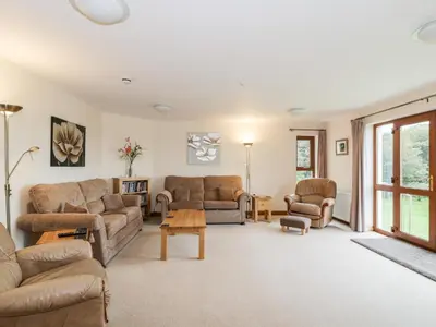 a living room with couches and a table at Cairnhapple House in Stranraer