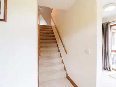 a staircase in a house with white walls at Cairnhapple House in Stranraer