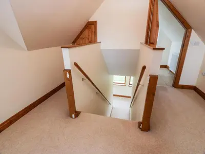 an attic room with a staircase with a mirror at Cairnhapple House in Stranraer