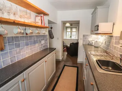 a kitchen with a sink and a counter top at Kestrel Cottage in Keswick