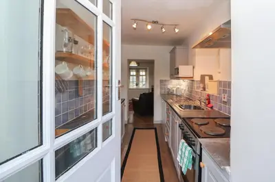 a kitchen with a counter and a stove top oven at Kestrel Cottage in Keswick