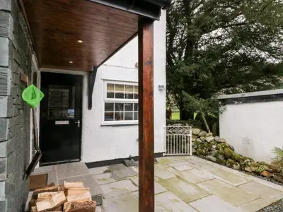 a porch of a house with a wooden door at Thwaite How in Keswick