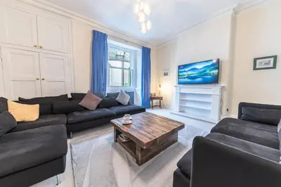 a living room with a couch and a coffee table at Town centre property convenient for the fells in Keswick