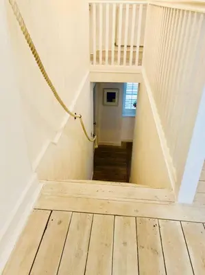 a stairway with a rope leading to a room at Bridgend Cottage, Auchencairn, Castle Douglas in Auchencairn