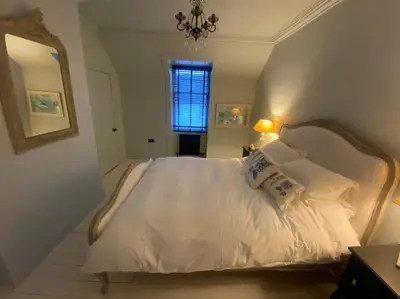 a bedroom with a bed with white sheets and pillows at Kirkcudbright 3 bed ultra modern brand new in Kirkcudbright