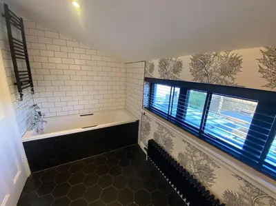 a bathroom with a bath tub and a window at Kirkcudbright 3 bed ultra modern brand new in Kirkcudbright