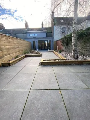 a building with a sidewalk in front of a building at Kirkcudbright 3 bed ultra modern brand new in Kirkcudbright