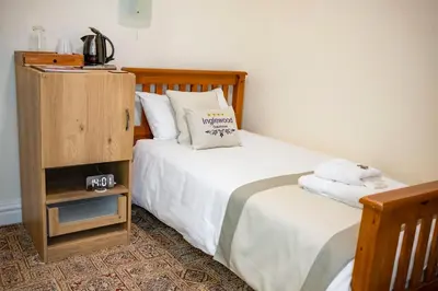 a bedroom with two beds and a dresser at OPUL EXPRESS - Inglewood in Douglas