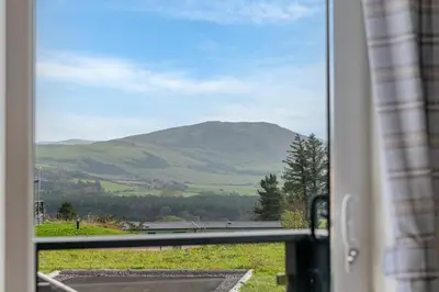 a view of a mountain from a window at Birch Timber Holiday Lodge in Bassenthwaite