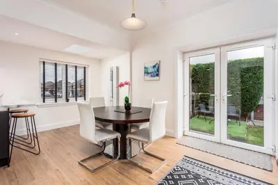 a dining room with a table and chairs at Berelands House - Donnini Apartments in Prestwick