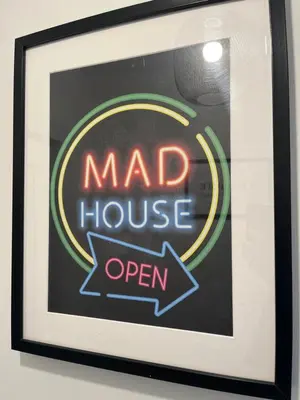 a framed sign for a mad house open at The Boyd - Coorie Doon in Prestwick