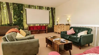 a living room with two couches and a table at Historic St Bees Farmhouse Hot Tub Games Summer Gatherings in St Bees