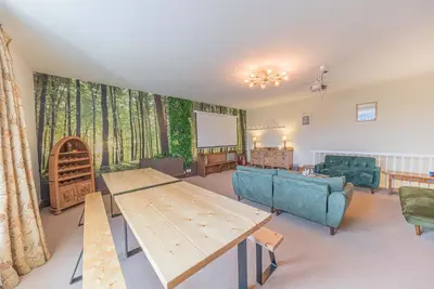 a living room with a couch and a table at Historic St Bees Farmhouse Hot Tub Games Summer Gatherings in St Bees