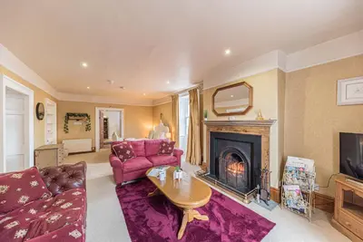 a living room with a couch and a fireplace at Historic St Bees Farmhouse Hot Tub Games Summer Gatherings in St Bees