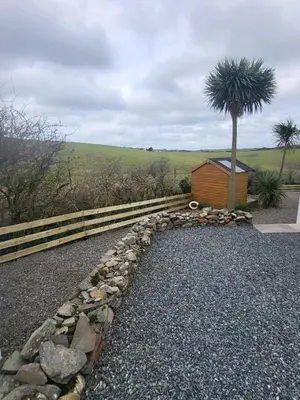 a rock pathway with a tree and a building at RAWSON COTTAGE LOVELY 2 BEDROOM SEMI RURAL in Stranraer