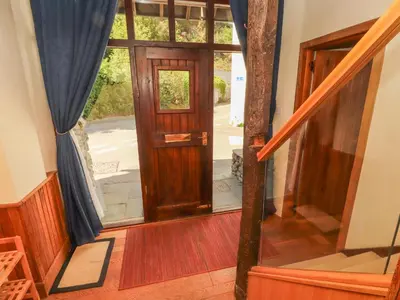 an open wooden door in a house with stairs at Beck Edge in Keswick