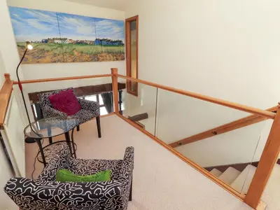 a balcony with a glass table and a chair at Beck Edge in Keswick