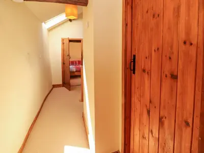 a hallway with a wooden door in a room at Beck Edge in Keswick