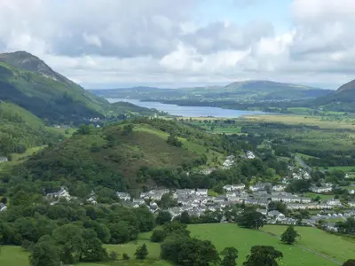 an aerial view of a town and a lake in the mountains at Spa Cottage in Braithwaite