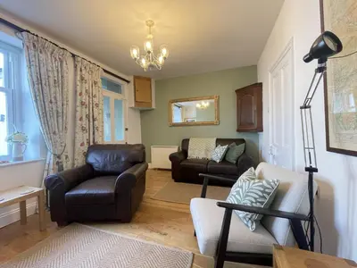 a living room with a couch and a chair at Spa Cottage in Braithwaite