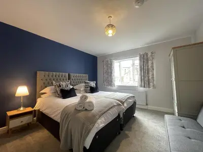 a bedroom with a large bed and a window at Red Robin in Keswick