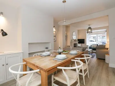 a kitchen and living room with a wooden table and chairs at Forty Five in Keswick
