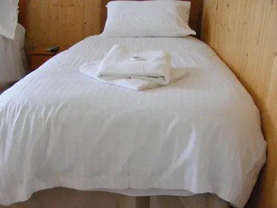 a white towel sitting on top of a white bed at Trevelyan Hotel in Douglas