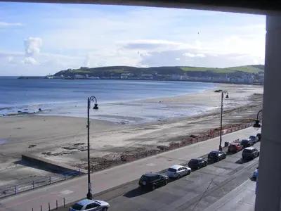 a view of a beach with cars parked on the road at Trevelyan Hotel in Douglas