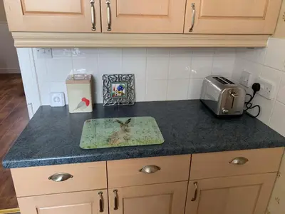 a kitchen counter with a toaster on a counter top at Glenterry Farmhouse in Kirkcudbright
