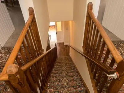 an overhead view of a staircase with wooden railings at Glenterry Farmhouse in Kirkcudbright