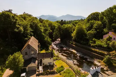 an aerial view of an old church next to a river at Bridge Cottage Keswick in Keswick
