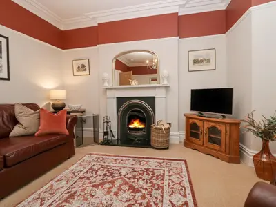 a living room with a fireplace and a television at Heatherlea in Keswick