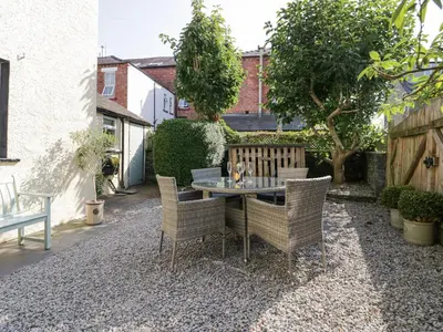 a patio with a table and chairs in a yard at Heatherlea in Keswick