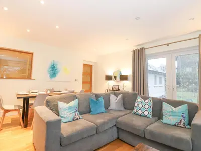 a living room with a couch and a table at Tandarra in Keswick