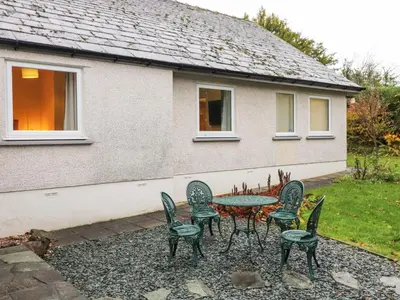 a table and chairs in front of a house at Tandarra in Keswick