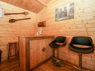 two chairs in a room with wooden walls at Ballinorig Lodge in Cleator Moor