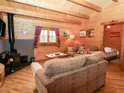 a living room with a couch and a table at Ballinorig Lodge in Cleator Moor