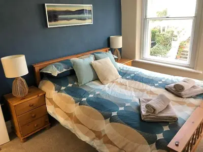 a bedroom with a bed and a window at Fell Top View - Fantastic Keswick Centre apartment in Keswick
