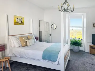 a white bedroom with a bed and a window at Muirston Farmhouse - Uk44977 in Ayr