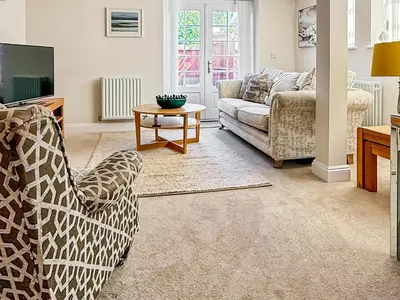 a living room with a couch and a table at The Police Station - Uk45642 in Silloth