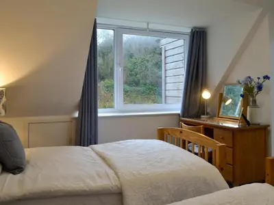 a bedroom with a bed and a window at Clachries Cottage in Boreland of Colvend